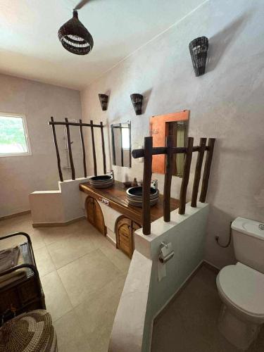 a bathroom with a toilet and a sink at Villa Oasis in Nguékokh