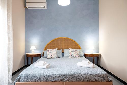 a bedroom with a large bed with two night stands at A casa di Pietro Sei in Leporano
