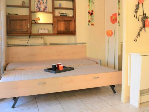 a bed with a tray on it in a room at Studio climatisé avec terrasse et garage - 4 couchages - FR-1-251-223 in Le Lavandou