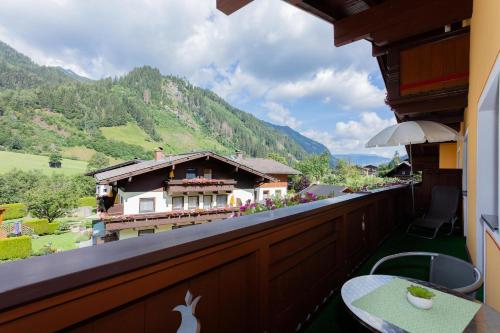 a balcony with a view of a house in the mountains at Rainberghof***, Appartements in Rauris