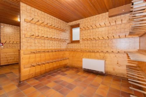 a large room with wooden walls and shelves in a room at Rainberghof***, Appartements in Rauris