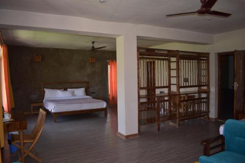 a bedroom with a bed and a living room at Nubra Ecolodge in Liekzan