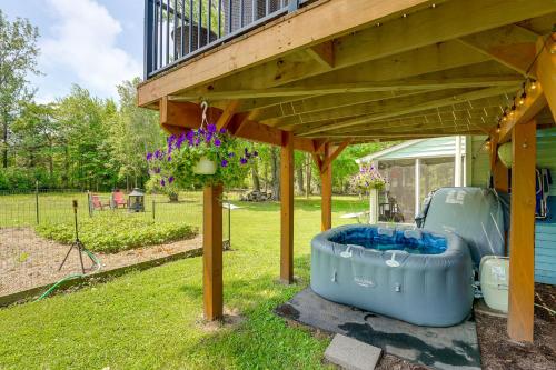 a pergola with a hot tub under a deck at Quiet Country Studio Between Saugatuck and Holland! in Holland