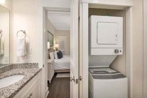 a bathroom with a sink and a washer and dryer at 400 Ocean #2207 in Saint Simons Island
