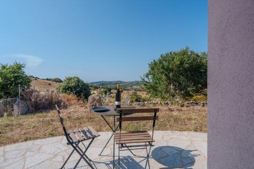a table and two chairs sitting on a patio at Il Sughereto In Vigna in Aglientu