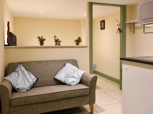 a living room with a couch with two pillows at Danika East in Threlkeld