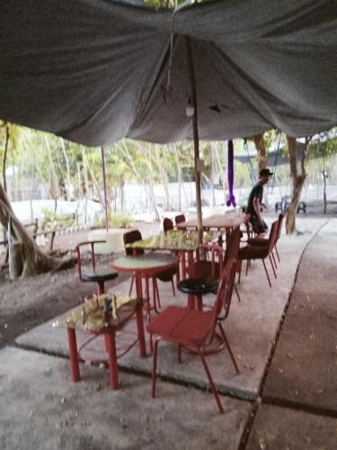 a group of tables and chairs under an umbrella at PINOY YOGA POLE PIYOPO LA UNION fan kubo 4 pax in Rimus