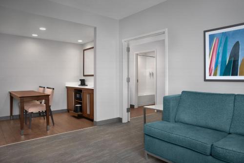 a living room with a couch and a table at Hampton Inn and Suites by Hilton Vero Beach-Downtown in Vero Beach