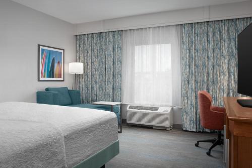 a hotel room with a bed and a desk at Hampton Inn and Suites by Hilton Vero Beach-Downtown in Vero Beach
