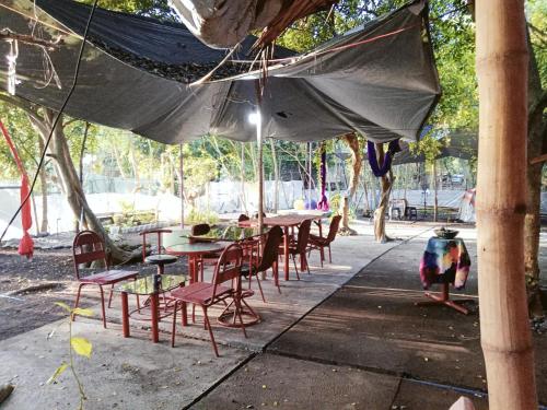 a group of tables and chairs under an umbrella at PINOY YOGA POLE PIYOPO LA UNION fan kubo 4 pax in Rimus