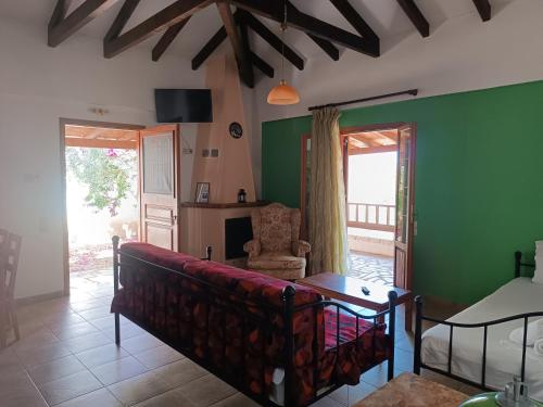 a living room with a couch and green walls at Mikro Xorio in Vathi, Mani