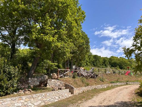 a dirt road next to a fence and trees at Bed and Breakfast Agriturismo La Palombara 