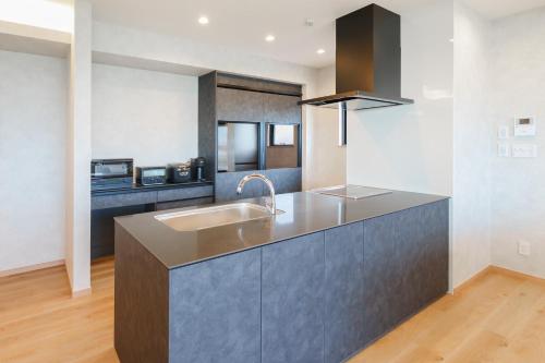 a kitchen with a sink and a counter top at One's You Villa Awaji in Awaji