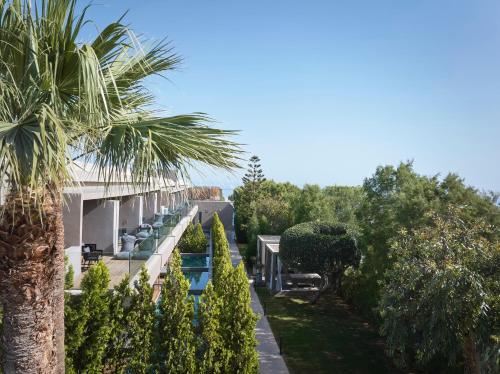 a view of the house from the garden at NEMA Design Hotel & Spa - Adults Only in Hersonissos