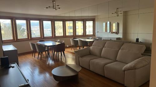 a living room with a couch and a table and chairs at Ribeiros House Infantado in Loures