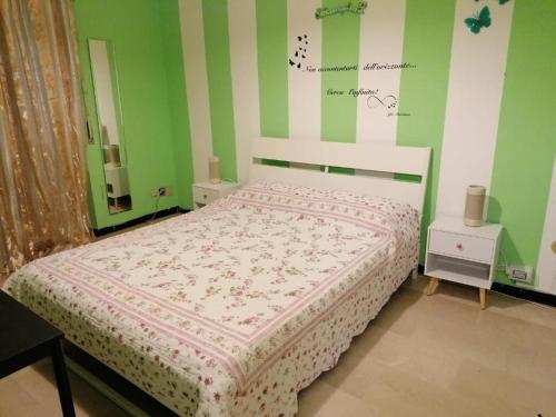 a bedroom with a bed with green and white stripes at Céline in Genova