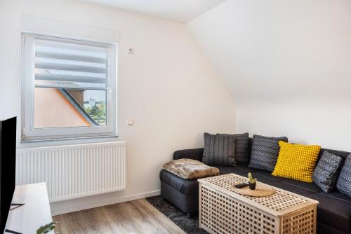 a living room with a couch and a window at Ferienwohnung Werratal in Barchfeld