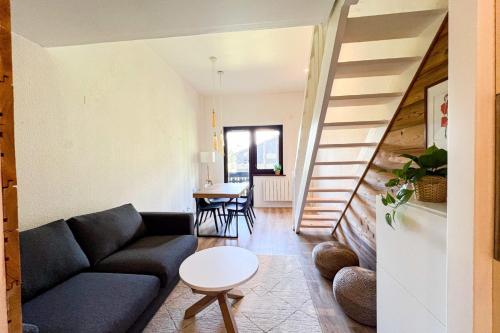 un salon avec un canapé et un escalier dans l'établissement Cozy apartment with view of Mont Blanc, à Chamonix-Mont-Blanc