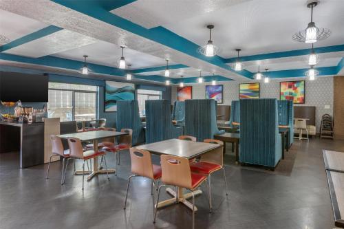 a restaurant with tables and chairs and blue ceilings at Best Western Plus Gallup Inn & Suites in Gallup