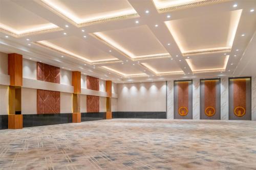 an empty room with a stage in a ballroom at D Square Statue of Unity Kevadia, a member of Radisson Individuals in Kevadia