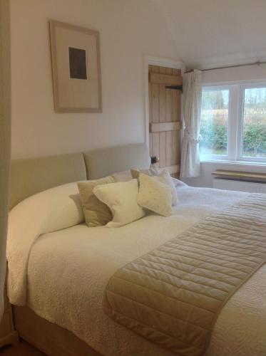 a bedroom with a bed with pillows and a window at Shakespeare's View in Stratford-upon-Avon