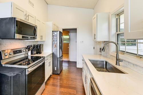 a kitchen with white cabinets and a stainless steel refrigerator at Launch and Dock Lake Norman Retreat with Scenic Deck in Mooresville
