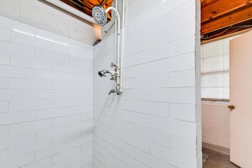 a bathroom with white subway tile and a shower at Launch and Dock Lake Norman Retreat with Scenic Deck in Mooresville