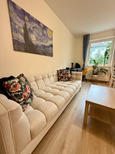 a living room with a couch and a table at Kraków Nest in Kraków