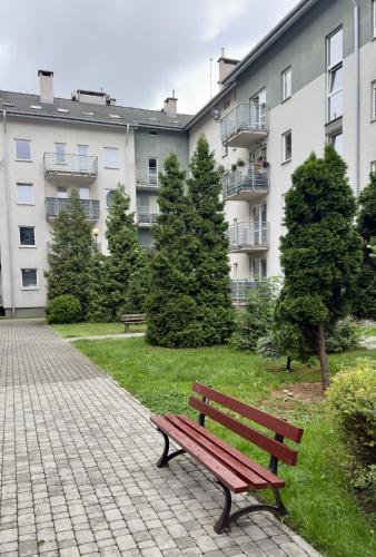 a park bench sitting in front of a building at Kraków Nest in Kraków
