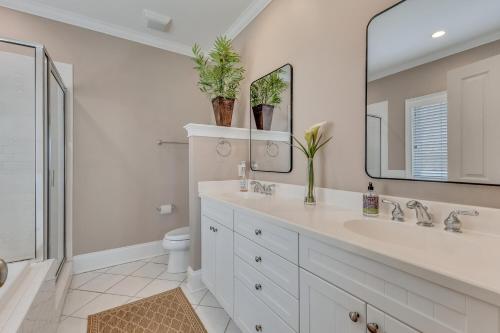 a bathroom with a sink and a toilet and a mirror at The Pelican in Carolina Beach