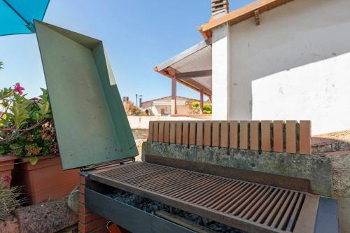 a door is open on a bench next to a building at Casa Elisa Montegrazie in Montegrazie