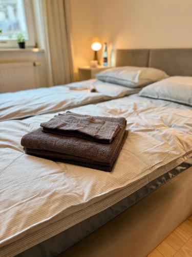 a brown towel sitting on top of a bed at Kraków Nest in Kraków