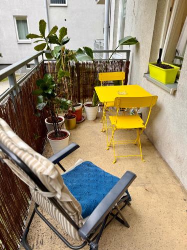 a yellow table and chairs on a balcony at Kraków Nest in Kraków