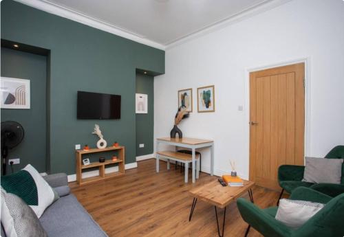 a living room with a couch and a table at 3BR Retreat High Barnes Wifi in Sunderland