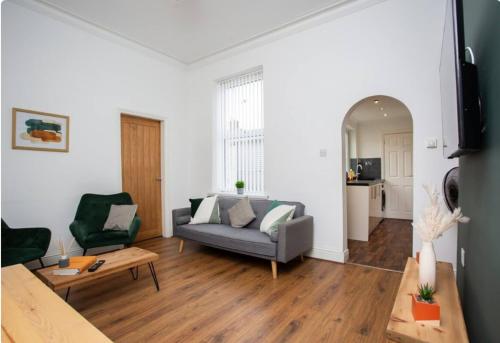 a living room with a couch and a table at 3BR Retreat High Barnes Wifi in Sunderland