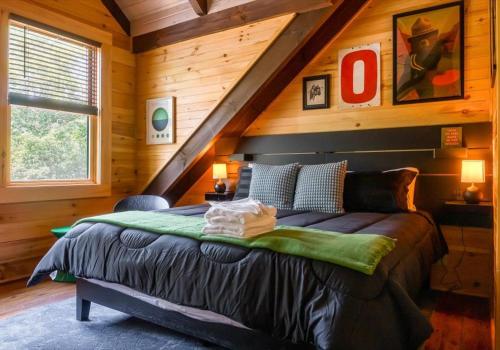 a bedroom with a bed in a log cabin at Chic Designer Log Cabin Hot Tub Pool Tabledecks in McGaheysville
