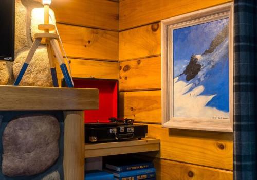 a room with a ladder and a picture on the wall at Chic Designer Log Cabin Hot Tub Pool Tabledecks in McGaheysville