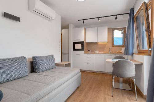 a living room with a couch and a kitchen at Unterdornerhof Algund in Lagundo