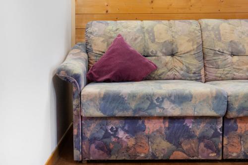 a couch with a purple pillow on it at Unterdornerhof Algund in Lagundo