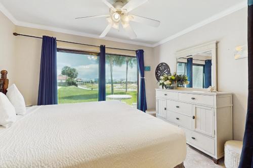 a bedroom with a white bed and a window at Sunset Harbor Palms 2 102 Luzviminda Cove in Navarre