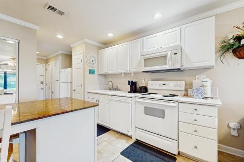 a kitchen with white cabinets and a counter top at Sunset Harbor Palms 2 102 Luzviminda Cove in Navarre