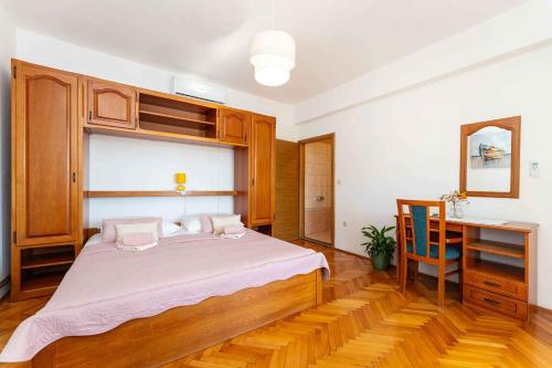 a bedroom with a large bed and a desk at Studio in Starigrad-Paklenica 43596 in Starigrad-Paklenica