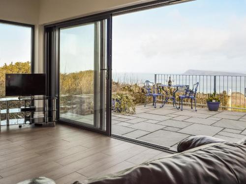a living room with a large sliding glass door at View At The Peak in Goodwick