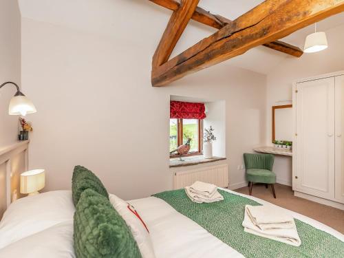 a bedroom with a white bed and a window at Paradise in Gisburn