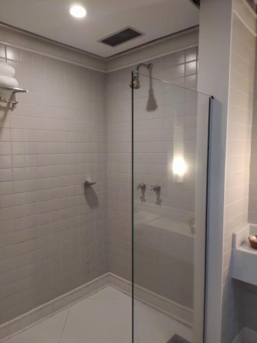 a shower with a glass door in a bathroom at Diamond Hotel in Rio de Janeiro