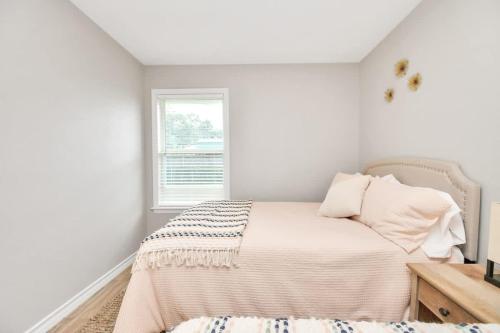 a white bedroom with a bed and a window at Cozy Houston Haven-Near Downtown & NRG in Houston