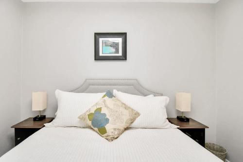 a bedroom with a white bed with two lamps at Cozy Houston Haven-Near Downtown & NRG in Houston