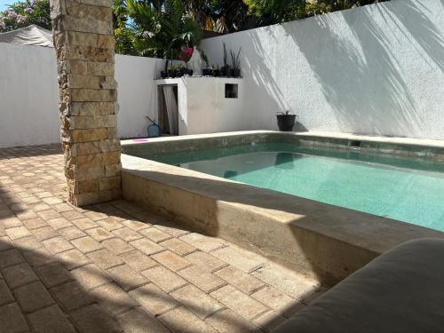 a small swimming pool in a backyard with at CASA COLIBRÍ - Solo Mujeres! & lgbt friendly in Mérida