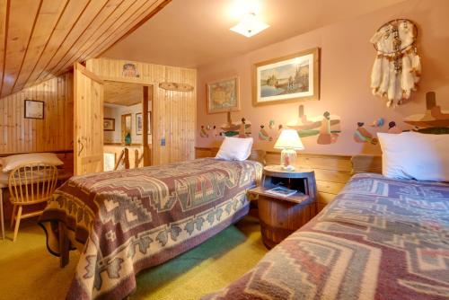 a bedroom with two beds and a table at Handcrafted Log Cabin in Candor Group Getaway! in Candor