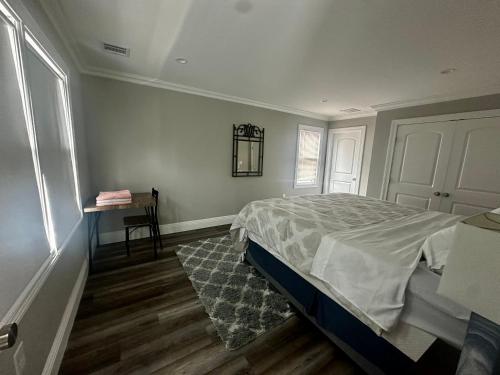 a bedroom with a bed and a table in it at Belmar NJ 5 Min Walk to Beach in Belmar